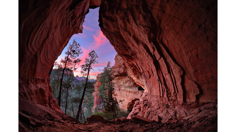 Trees And Sky Seen Through Cave During Sunset