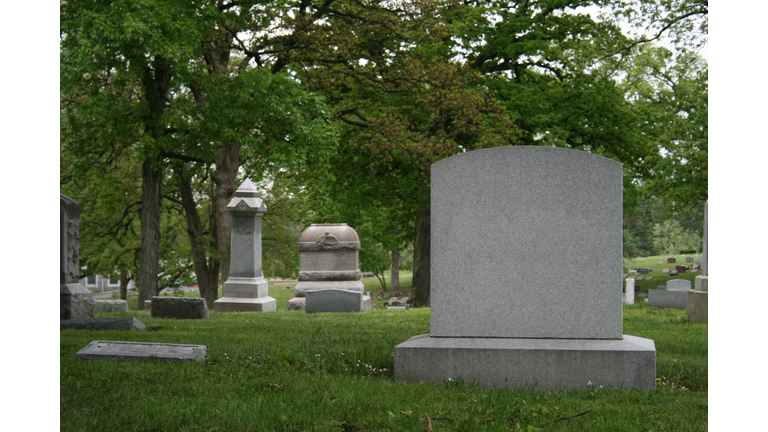 A cemetery and tombstone in the daylight