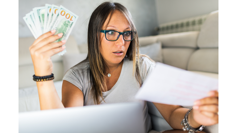 Woman calculating bills at home