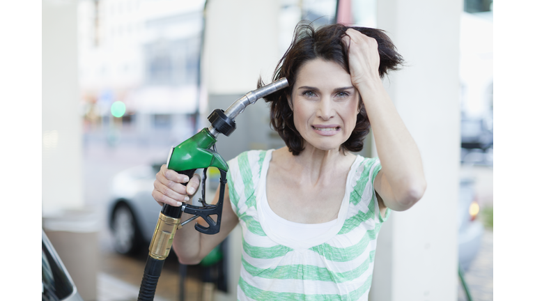 Frustrated woman pumping gas into hair