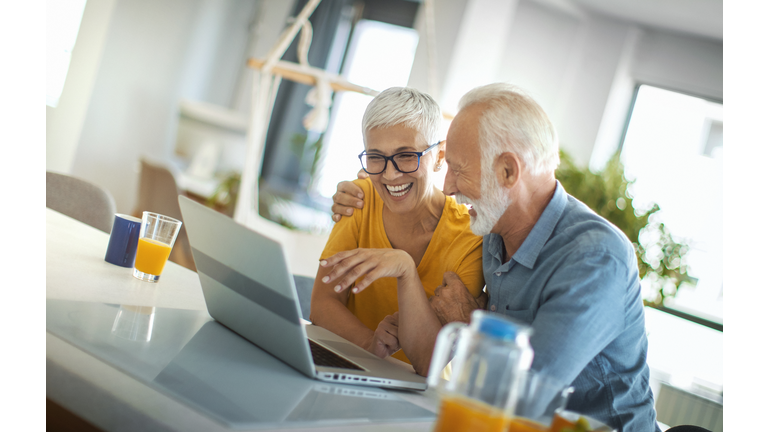 Mature couple buying some goods online