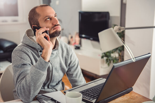 Frustrated man talking on smart phone