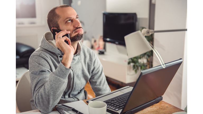Frustrated man talking on smart phone