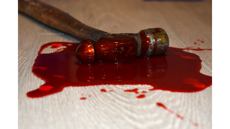 Hammer in blood on floor