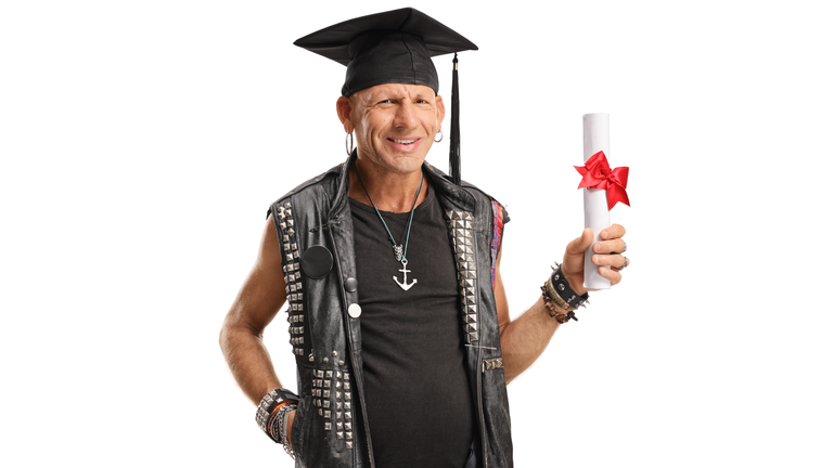 Mature punk man with a college diploma smiling at the camera