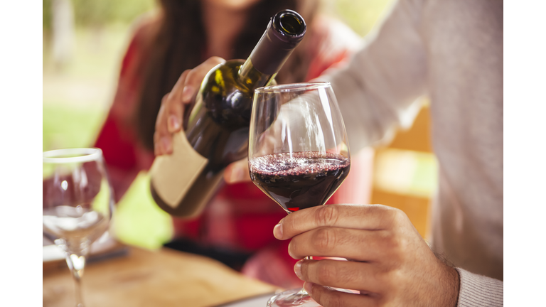 Man pouring red wine into glass