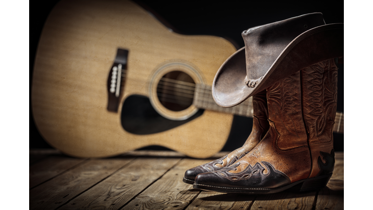 Country music festival live concert with acoustic guitar, cowboy hat and boots