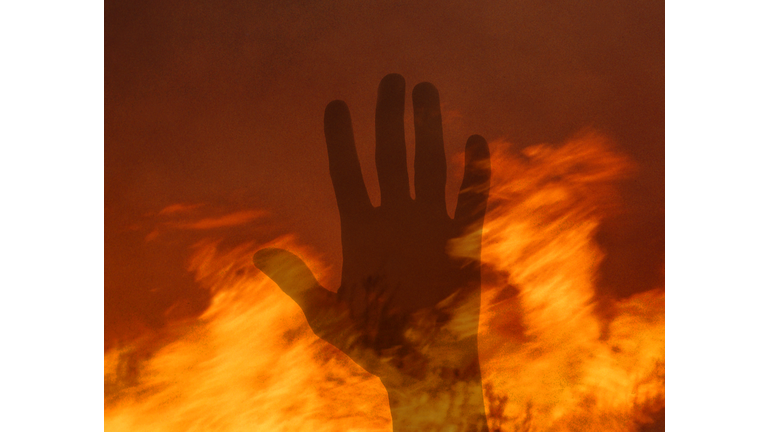 Single male hand in fire.