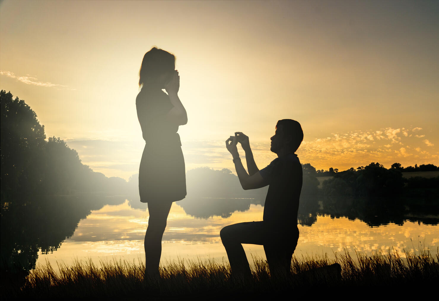 Wedding proposal. Dating at sun set. Man giving ring.