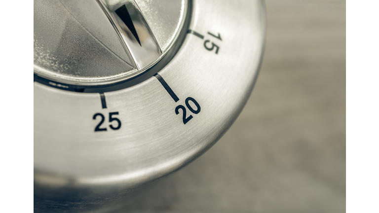20 Minutes - Macro Of An Analog Chrome Kitchen Timer On Wooden Table