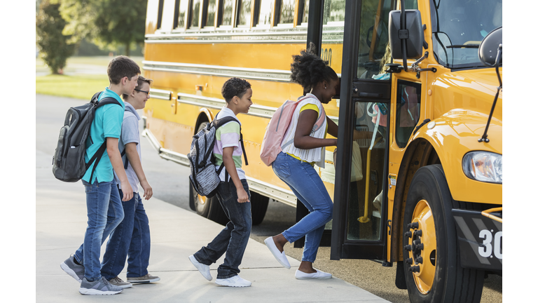 Middle school students boarding a bus