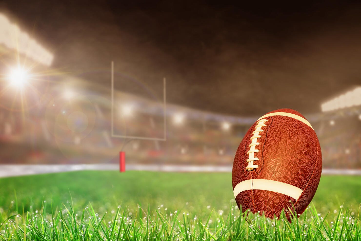 Outdoor Football Stadium With Ball on Grass and Copy Space