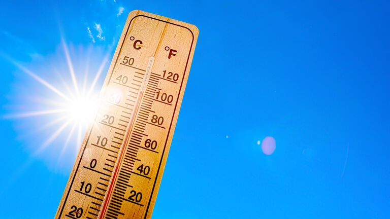 Sky with bright sun and thermometer