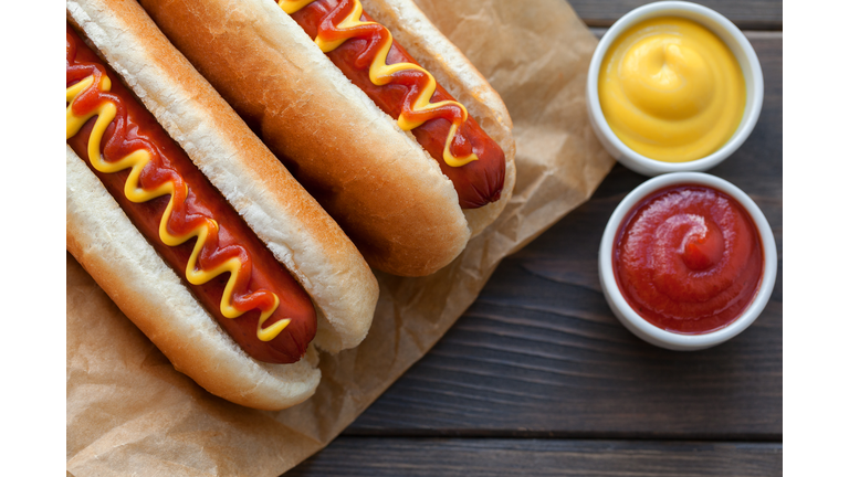 Barbecue Grilled Hot Dog with Yellow Mustard on wooden table