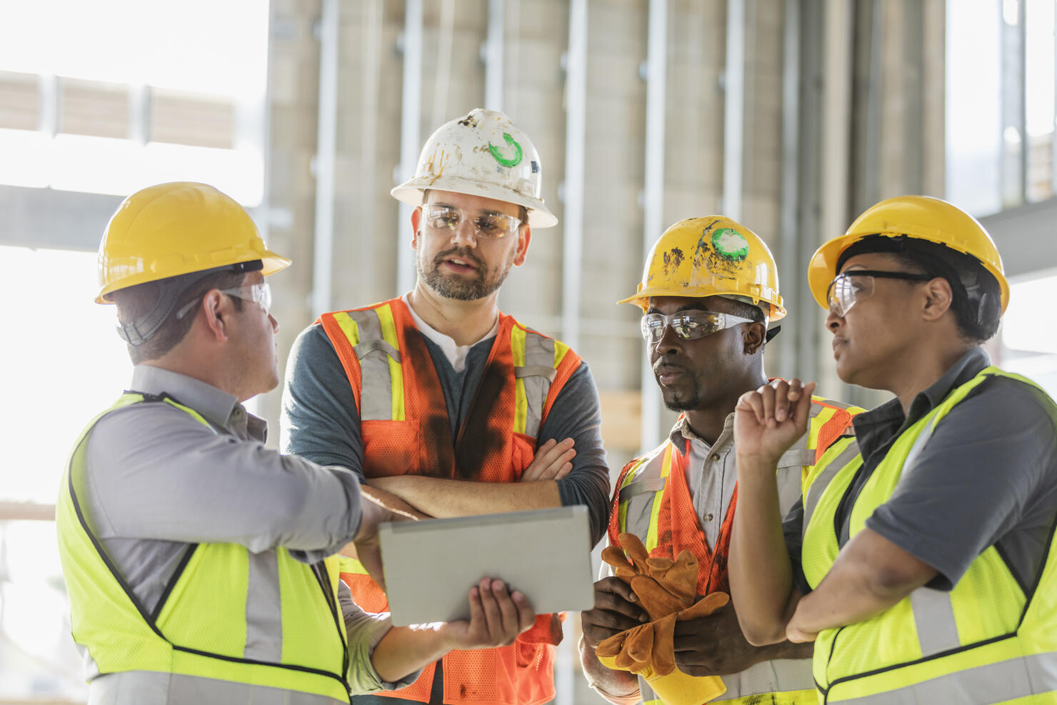 Construction workers looking at digital tablet