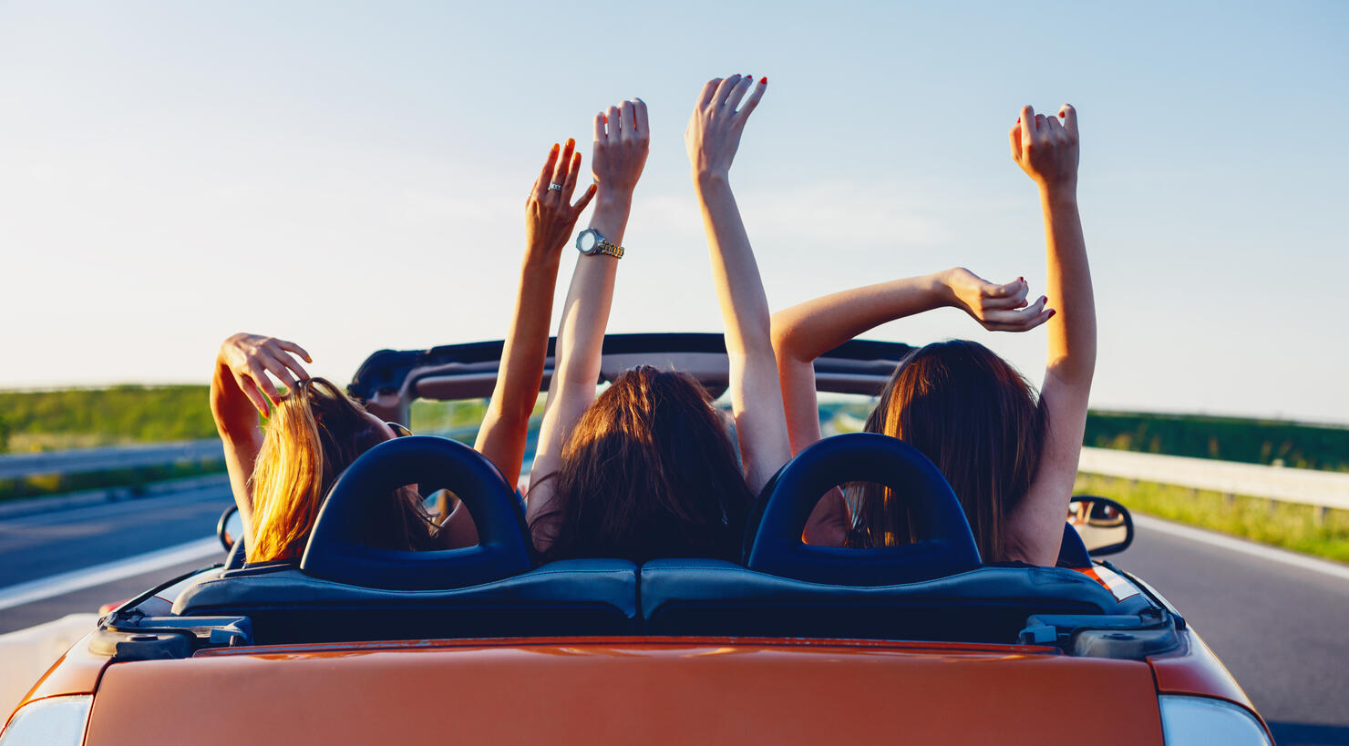 Young women on a road trip with cabriolet