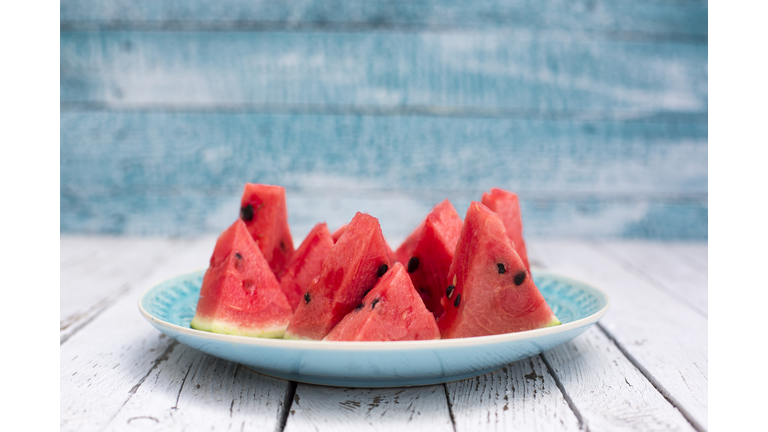 Chopped watermelon on blue plate