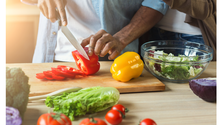 Black man preparing vegetable salad