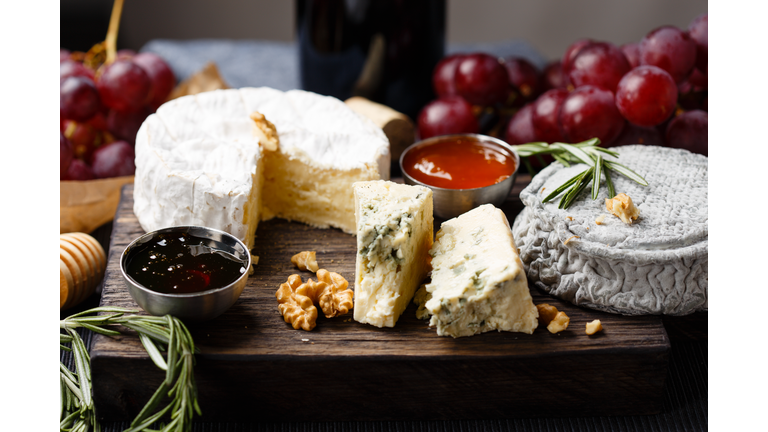 Cheese plate served with wine, jam and honey