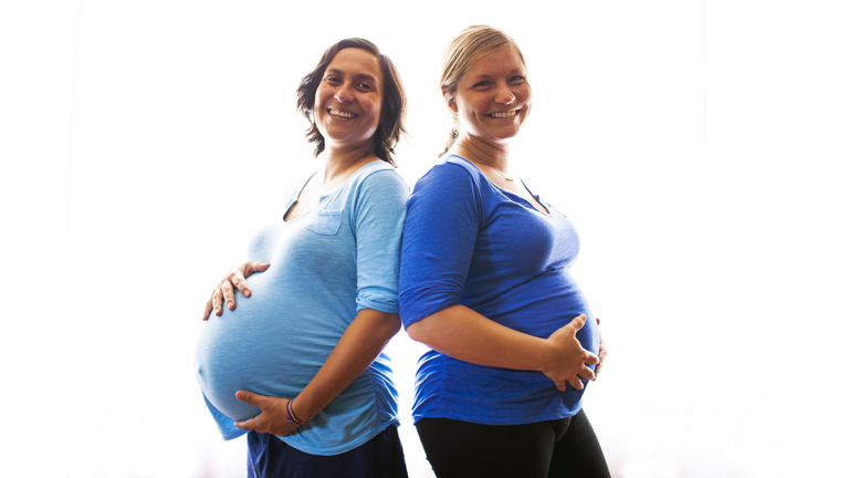 Pregnant women holding their bellies