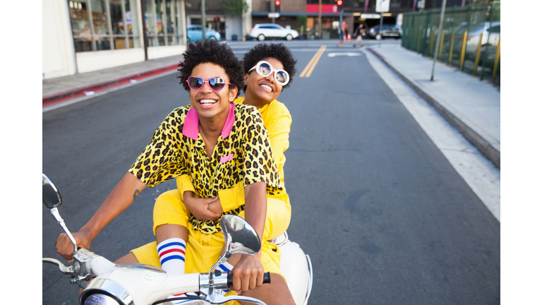 Young couple riding a scooter