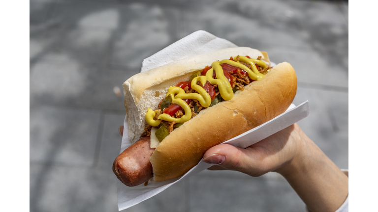 Woman's Hand holding hot dog