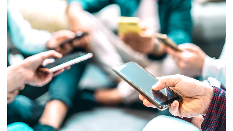 Close up of people using mobile smart phones - Detail of friends sharing photos on social media network with smartphone - Technology concept and cellphone culture with selective focus on right hand