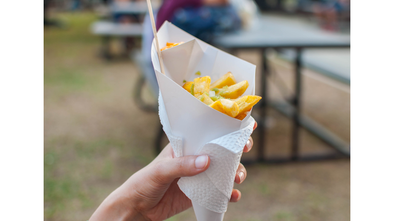 A woman is eating a french fries