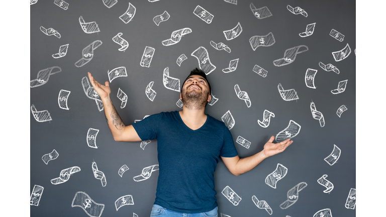 Excited man under a shower of money