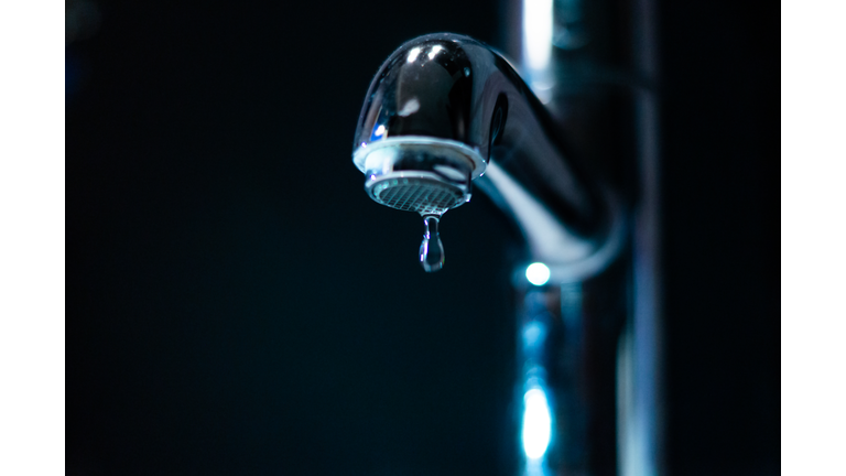 Close-Up Of Water Pouring From Faucet