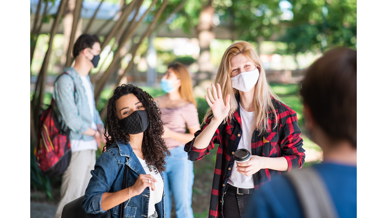 Small group of young student people meeting at university during the coronavirus pandemic
