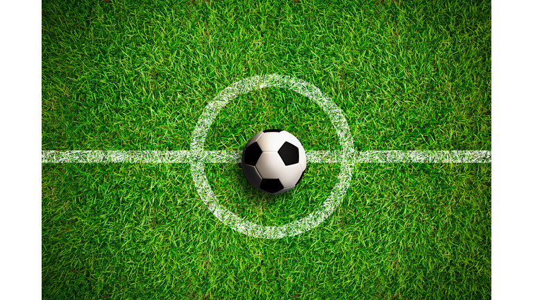 Overhead view on isolated soccer ball in field