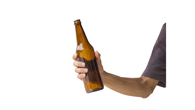 Cropped Hand Holding Beer Bottle Against White Background