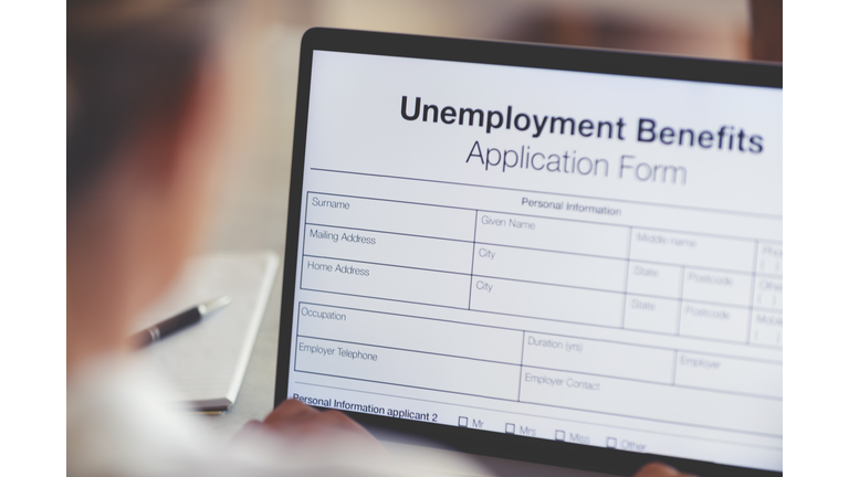 Woman filling out an online unemployment benefits application form.