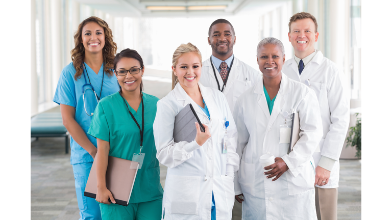 Large diverse group of hospital doctors, surgeons, and nurses