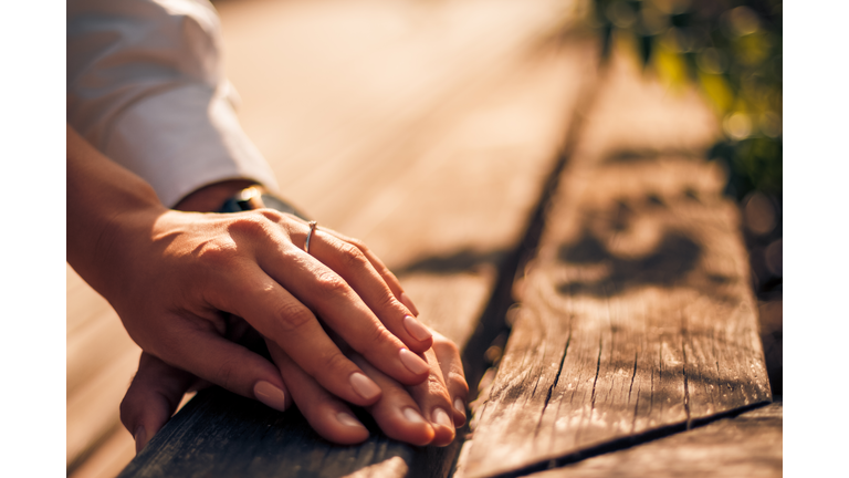 Holding Hands with wedding rings, wedding and engagement background