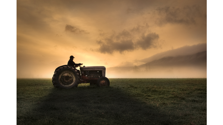 Farmer riding tractor