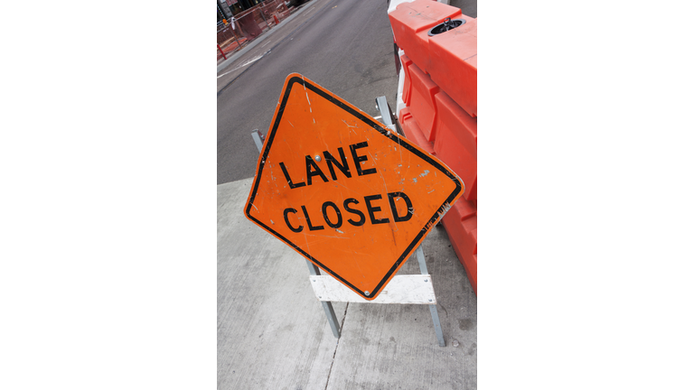 lane closed road sign on street