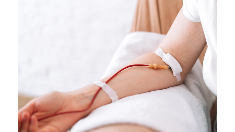 Girl sitting in chair donates blood