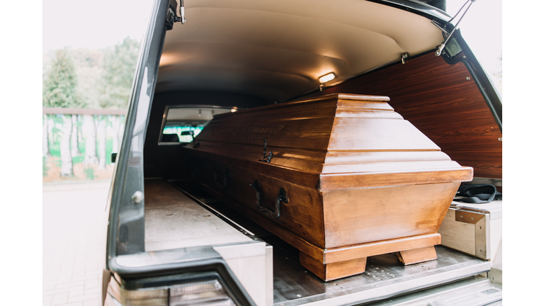 photo of a coffin car at a funeral