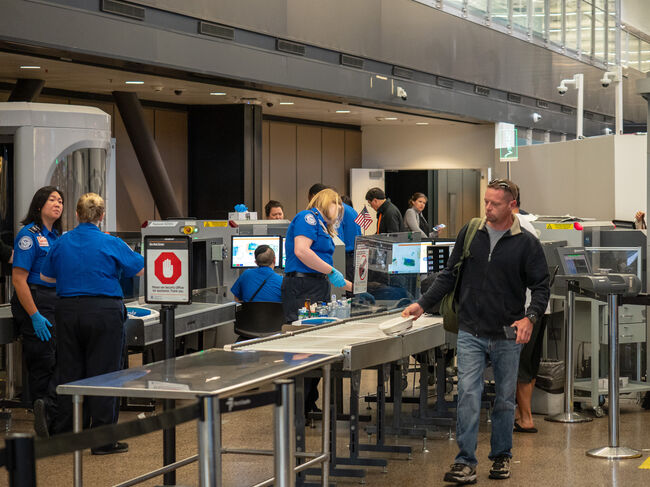 Man passes though Transportation Security Administration TSA security checkpoint at Seattle-Tacoma International Airport