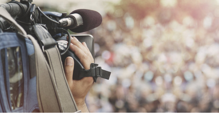 Cameraman shooting crowd