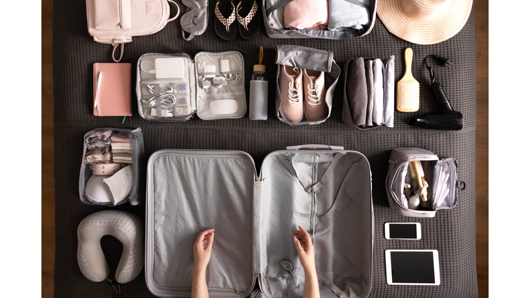 Woman Packing Suitcase For Travelling