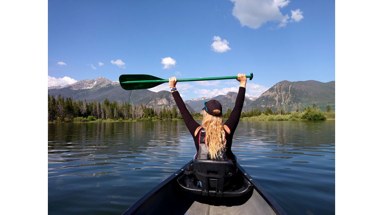 blond girl enjoys canoeing