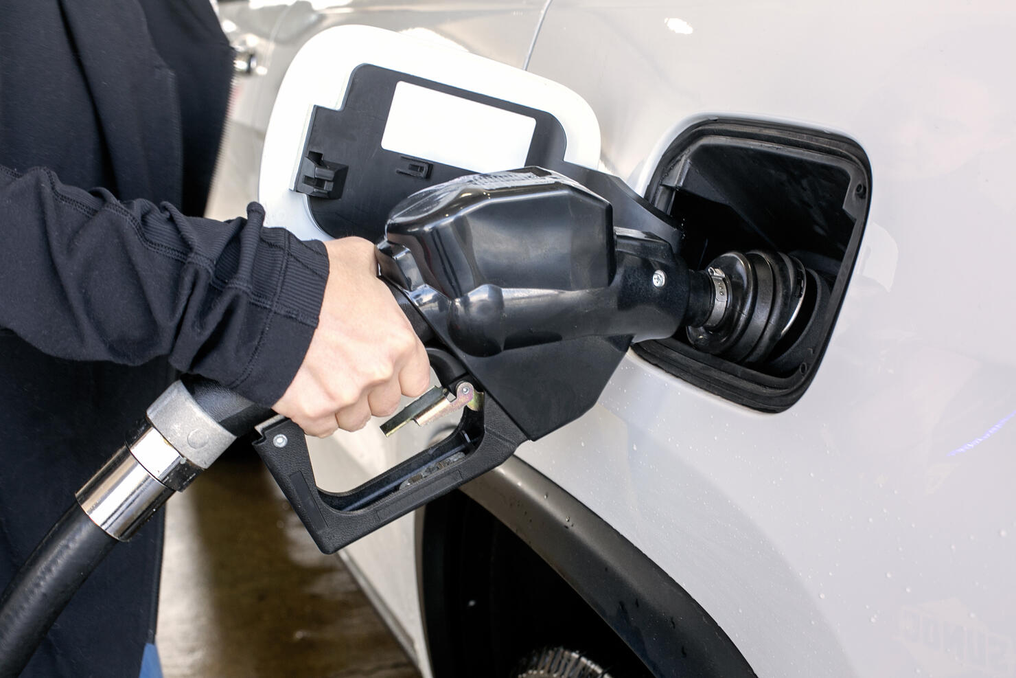 Car fueling at gas station.
