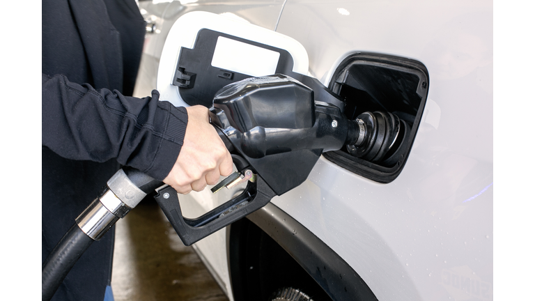 Car fueling at gas station.