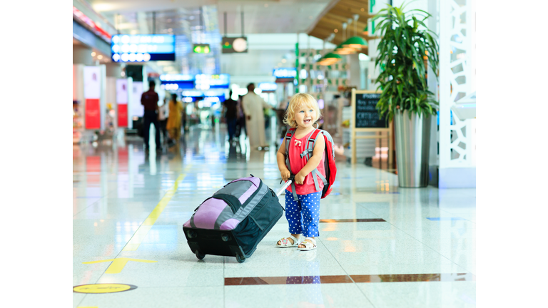 little girl with suitcase travel in the airport