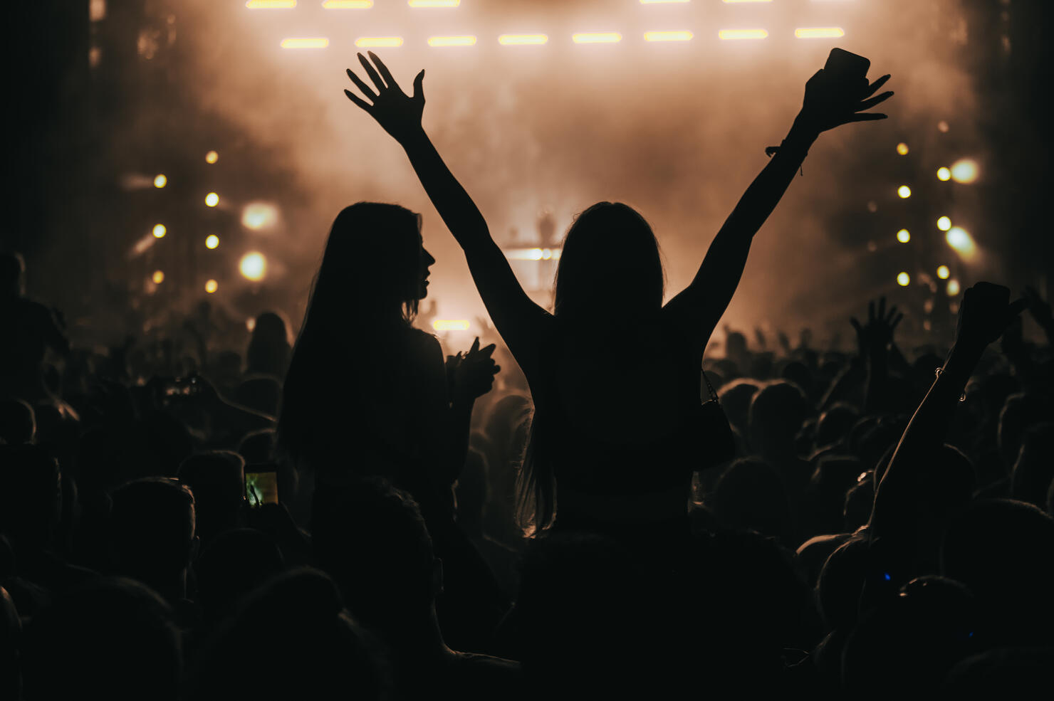 Two woman in the crowd at a music festival