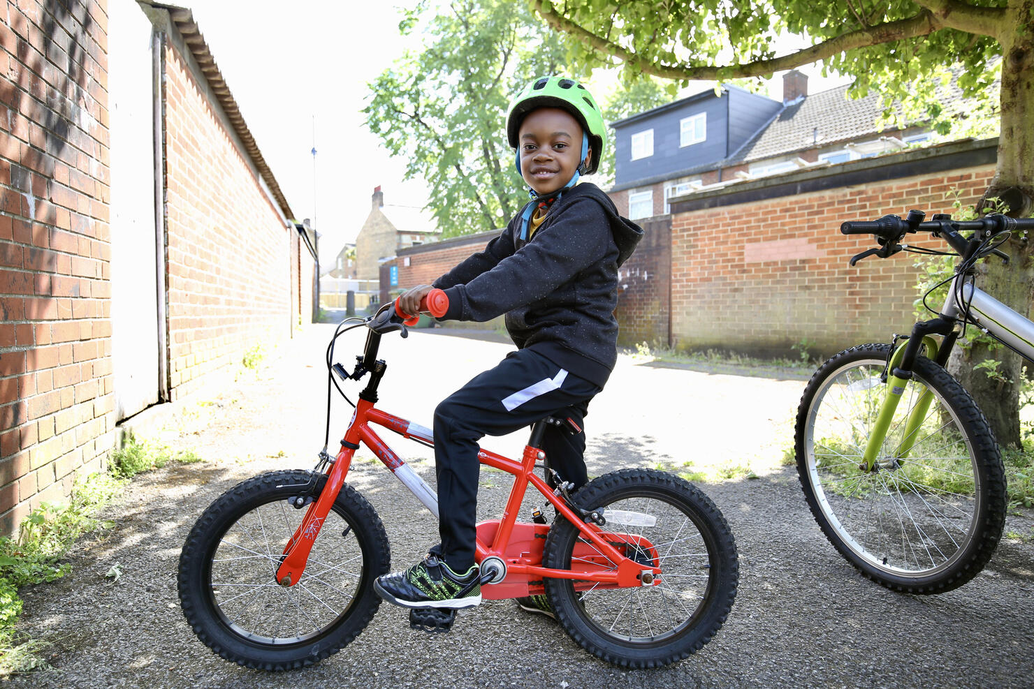 Boy on a red bike wearing a helmet