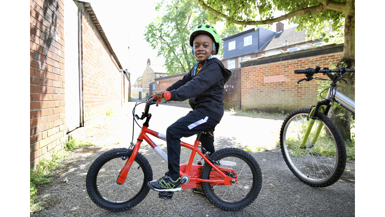 Boy on a red bike wearing a helmet